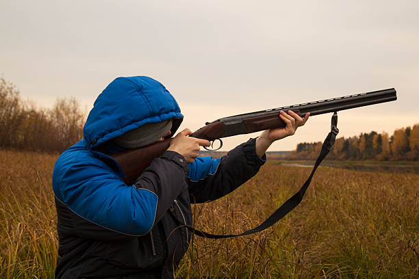 istock Duck hunting . A man with a gun on a duck hunt. 2239993056