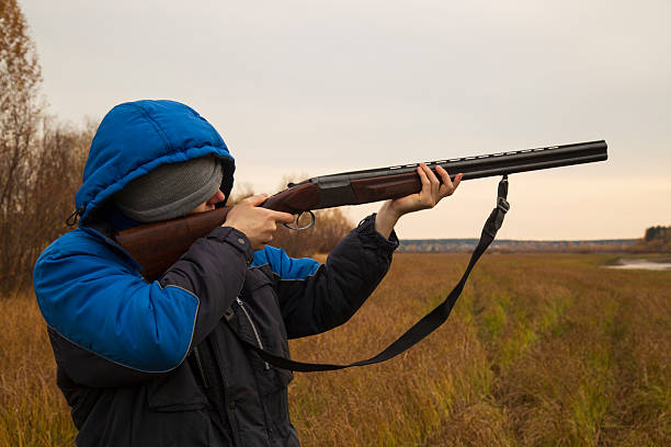 istock Duck hunting . A man with a gun on a duck hunt. 2239993092