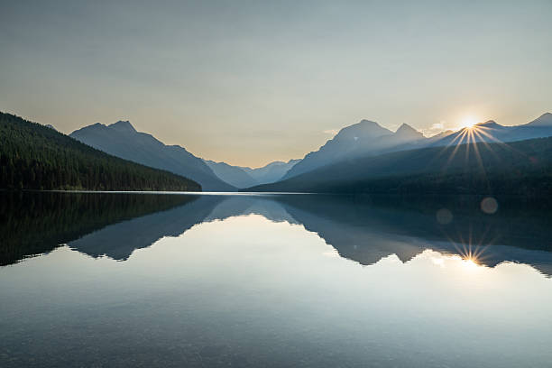 istock Sun Burst Breaks the Ridge of Mountains Behind Bowman Lake 2239994549