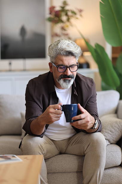 istock Man sitting alone at home looking sad and distraught 2239995201