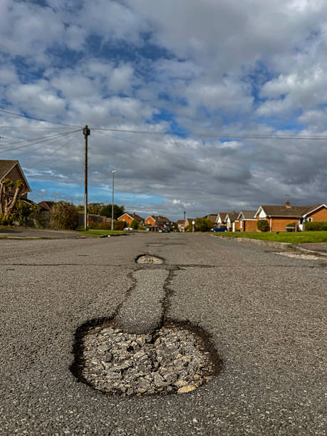 istock Potholes on a residential road (series) 3 2239995578