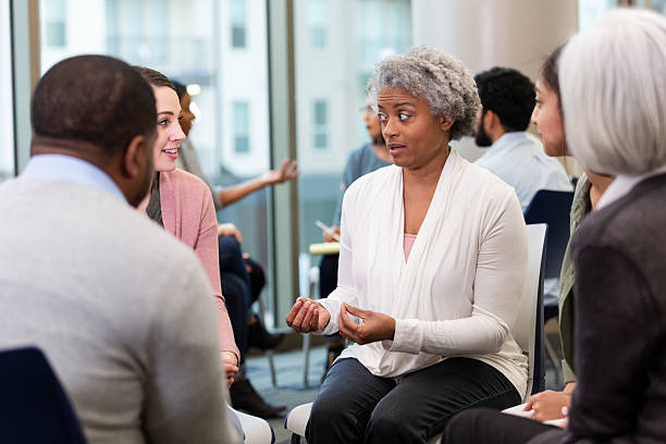 istock Diverse group of people in a supportive therapy session, engaging in open discussion. 2239995867
