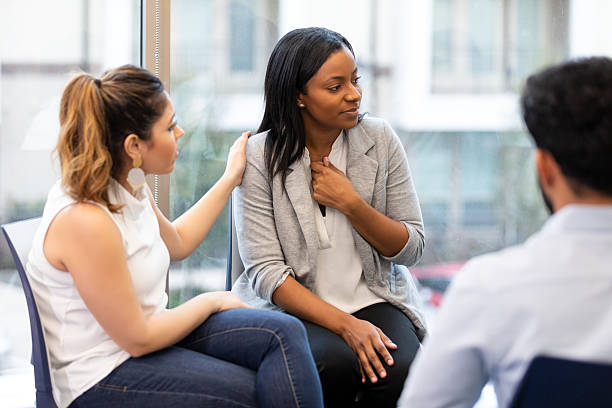 istock Three adults engage in supportive conversation, offering comfort and empathy during a group session. 2239995895