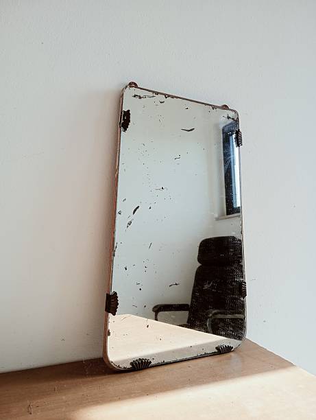 istock Vintage Distressed Mirror Leaning Against a White Wall 2239999828