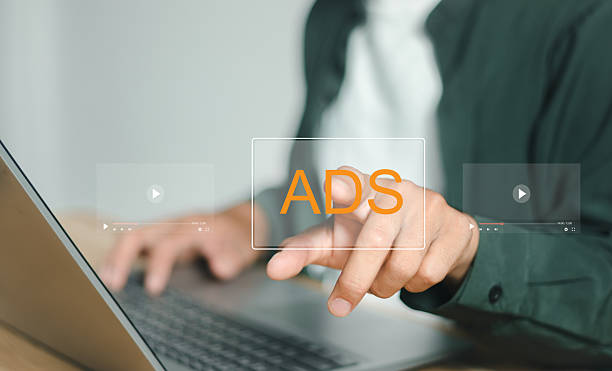 Ads text on laptop display screen from advertisers on internet. Ads banner campaign to target.digital marketing concept.online rich media native targeting advertising marketing strategy.