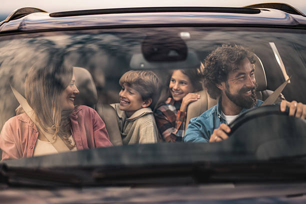istock Happy family going on a road trip by car. 2240000475