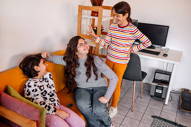 istock Girls at home having fun spending time with female babysitter while using body paint for drawing on faces 2240001613