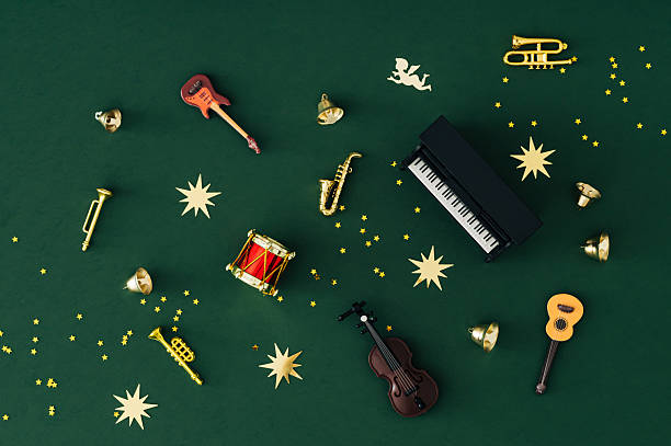 istock Unique pattern made of various musical instruments and golden glitter star confetti on green background. Christmas and New Year concept. Festive holiday music layout. Creative party flat lay image. 2240003045