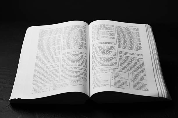 istock Open Holy Bible in English language on black table, closeup 2240003304