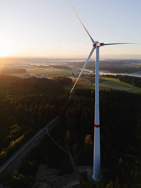 istock Wind Turbine at Sunrise Over Forest and Farmland 2240003321
