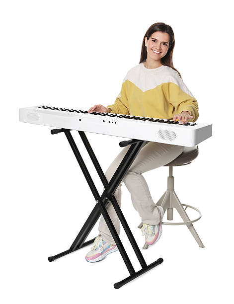 istock Smiling woman playing synthesizer on white background 2240003425