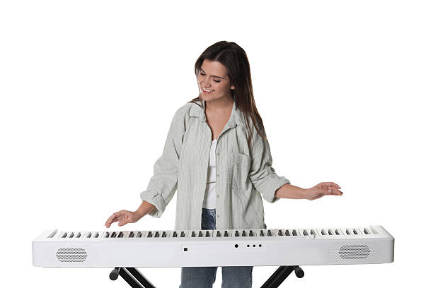 istock Smiling woman playing synthesizer on white background 2240003426