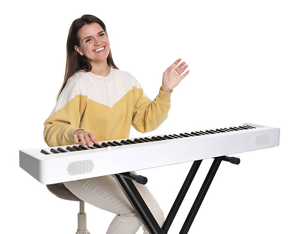 istock Smiling woman playing synthesizer on white background 2240003445