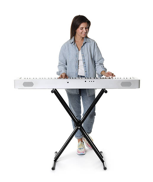 istock Smiling woman playing synthesizer on white background 2240003451