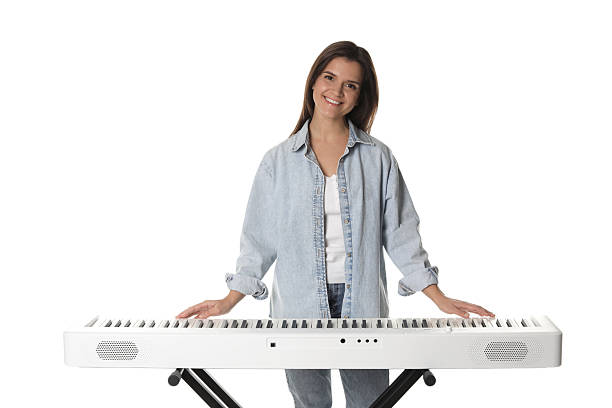 istock Smiling woman playing synthesizer on white background 2240003484