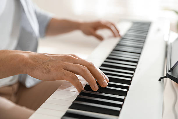 istock Man playing synthesizer indoors, closeup. Electronic musical instrument 2240003566