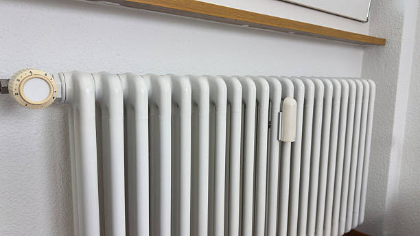 istock White Home Radiator Under Window — Central Heating System for Energy Efficiency and Warmth in Modern Interior Design 2240003780