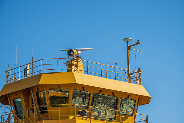 Ferry ship radar antennas against blue sky.