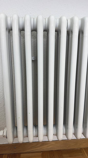 istock White Home Radiator Under Window — Central Heating System for Energy Efficiency and Warmth in Modern Interior Design 2240003819
