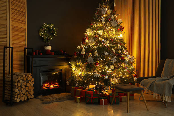 istock Christmas tree with festive decor, presents and fireplace in cozy room 2240005902