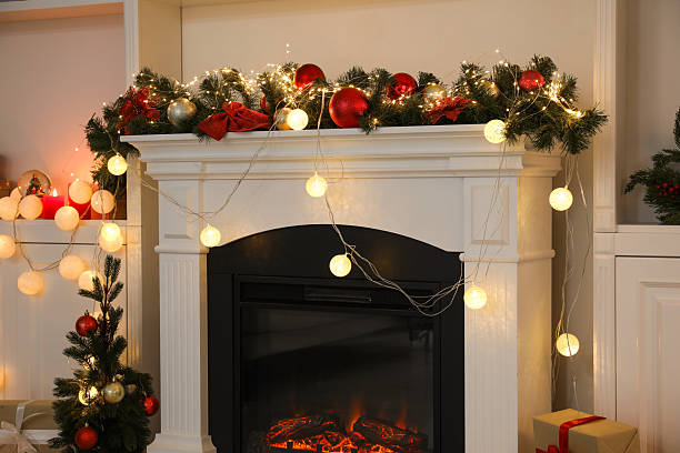 istock Stylish fireplace with Christmas decor in cozy room 2240005911
