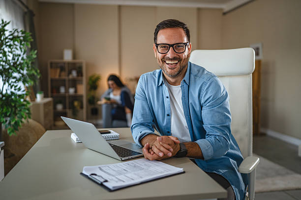istock Happy man working from home smiling at camera 2240006036