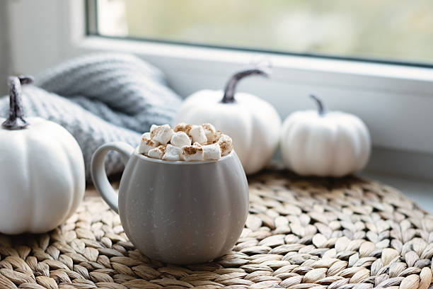 istock Autumn warming chocolate or coffee on windowsill. Autumn beverage 2240007826