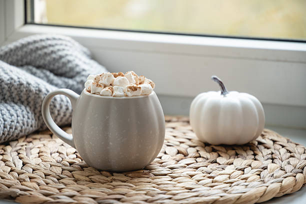 istock Autumn warming chocolate or coffee on windowsill. Autumn beverage 2240007833