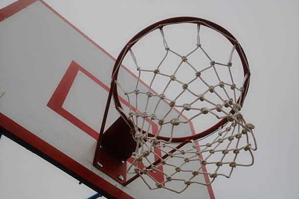 istock Looking up at a basketball hoop and backboard on an overcast day 2240008069