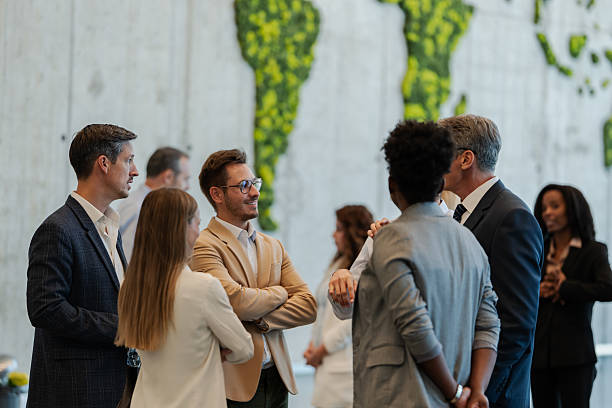 istock Business professionals networking at global conference with map 2240009447