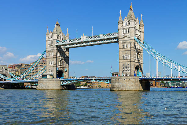 Daytime view of Tower Bridge spanning the River Thames in central London, England. The famous bascule and suspension bridge is one of the city’s most recognized landmarks.