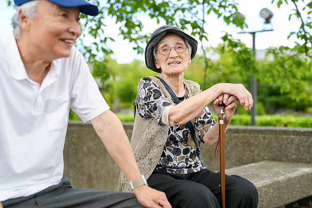 istock A man and woman are sitting on a bench, smiling at each other 2240011607
