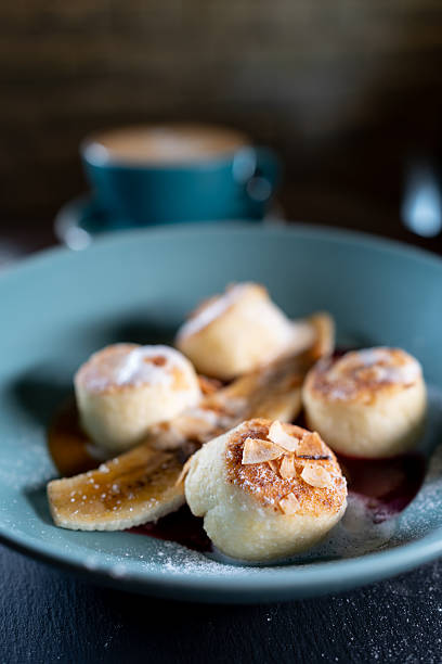 istock fresh coffee and cheese pancakes with banana, mango and berry sauce 2240013681