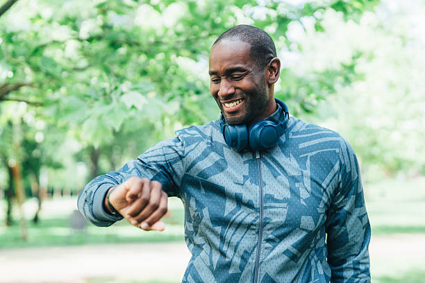 istock Young man checking progress on smartwatch outdoors 2240013825