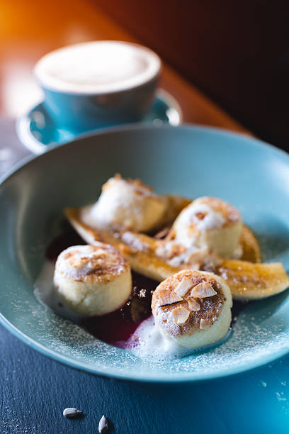 istock fresh coffee and cheese pancakes with banana, mango and berry sauce 2240014794