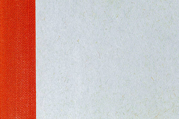 istock Close up notebook cover: red cloth binding and blue gray textured paper 2240015717