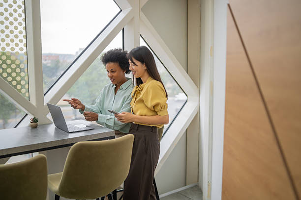 istock Businesswomen collaborating on laptop in modern office 2240020816