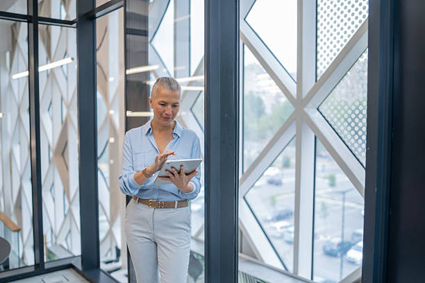istock Businesswoman using digital tablet in modern office building 2240020831