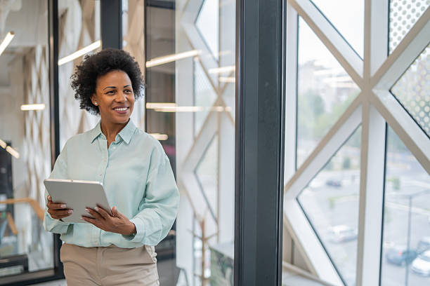 istock Smiling businesswoman holding digital tablet in modern office 2240020833