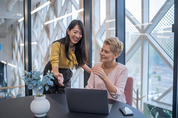 istock Businesswomen collaborating on laptop in modern office 2240020842