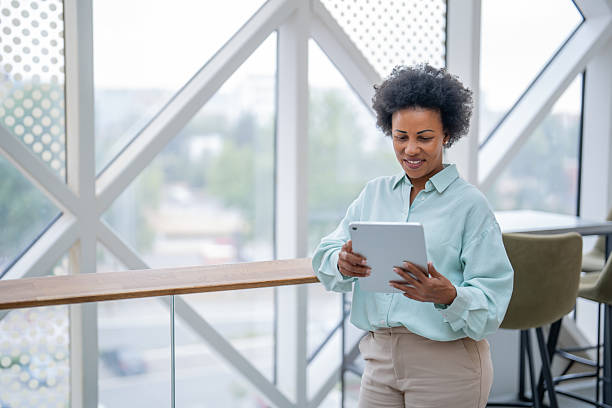 istock Smiling businesswoman using digital tablet in modern office 2240020863