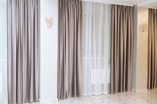 istock Elegant curtain design in a modern living room with soft lighting 2240021092