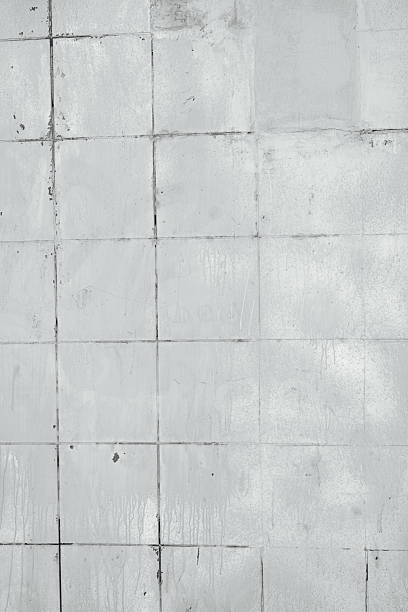 istock Old white tiles surface with dark lines showing wear and water stains creating texture 2240021211