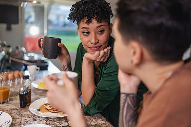 istock Lesbian Couple Sharing Breakfast in Cozy Kitchen 2240021683