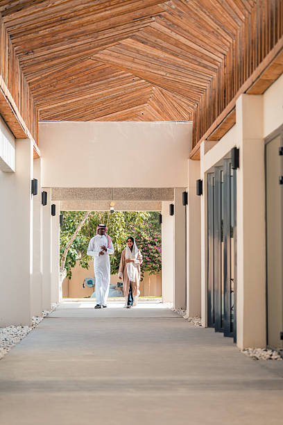 istock Young Arabic Couple Strolling in Modern Corridor 2240021827