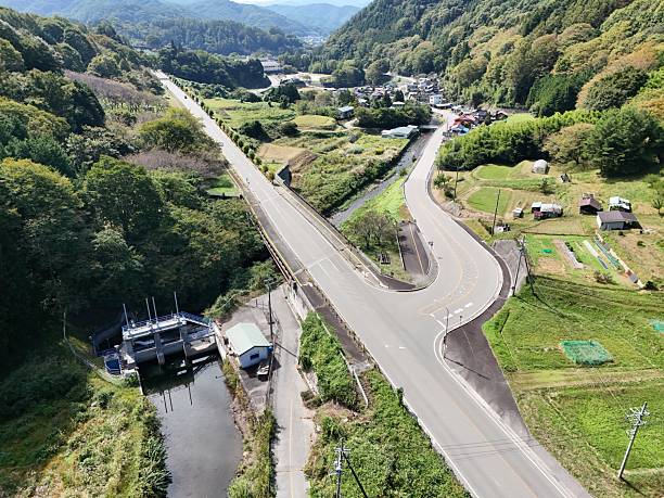 istock A road with a bridge over a river and a small town in the background 2240021849