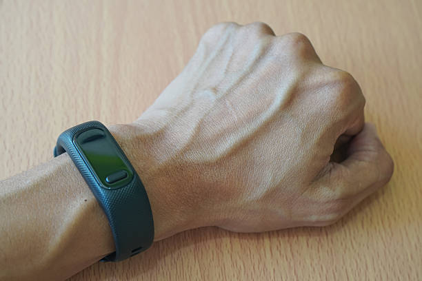 istock Close Up Fitness Tracker on Human Wrist 2240028362