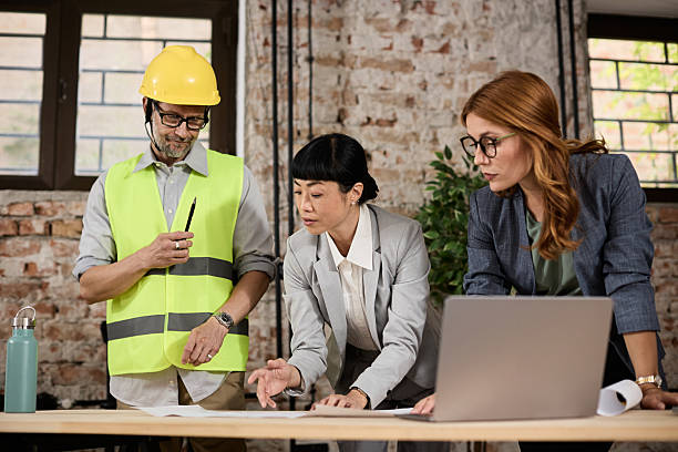 istock A team of experienced construction professionals discuss plans and deadlines at the planning table 2240029098