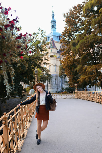 istock Traveler with backpack relaxing on historic bridge surrounded by fall foliage. 2240030210