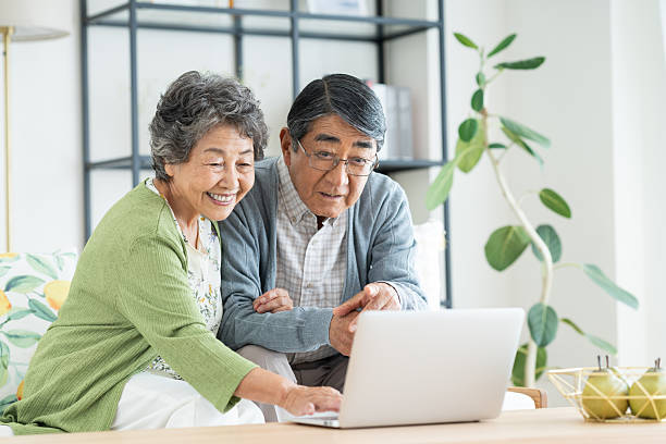 istock Senior couple using a computer in the living room 2240031835